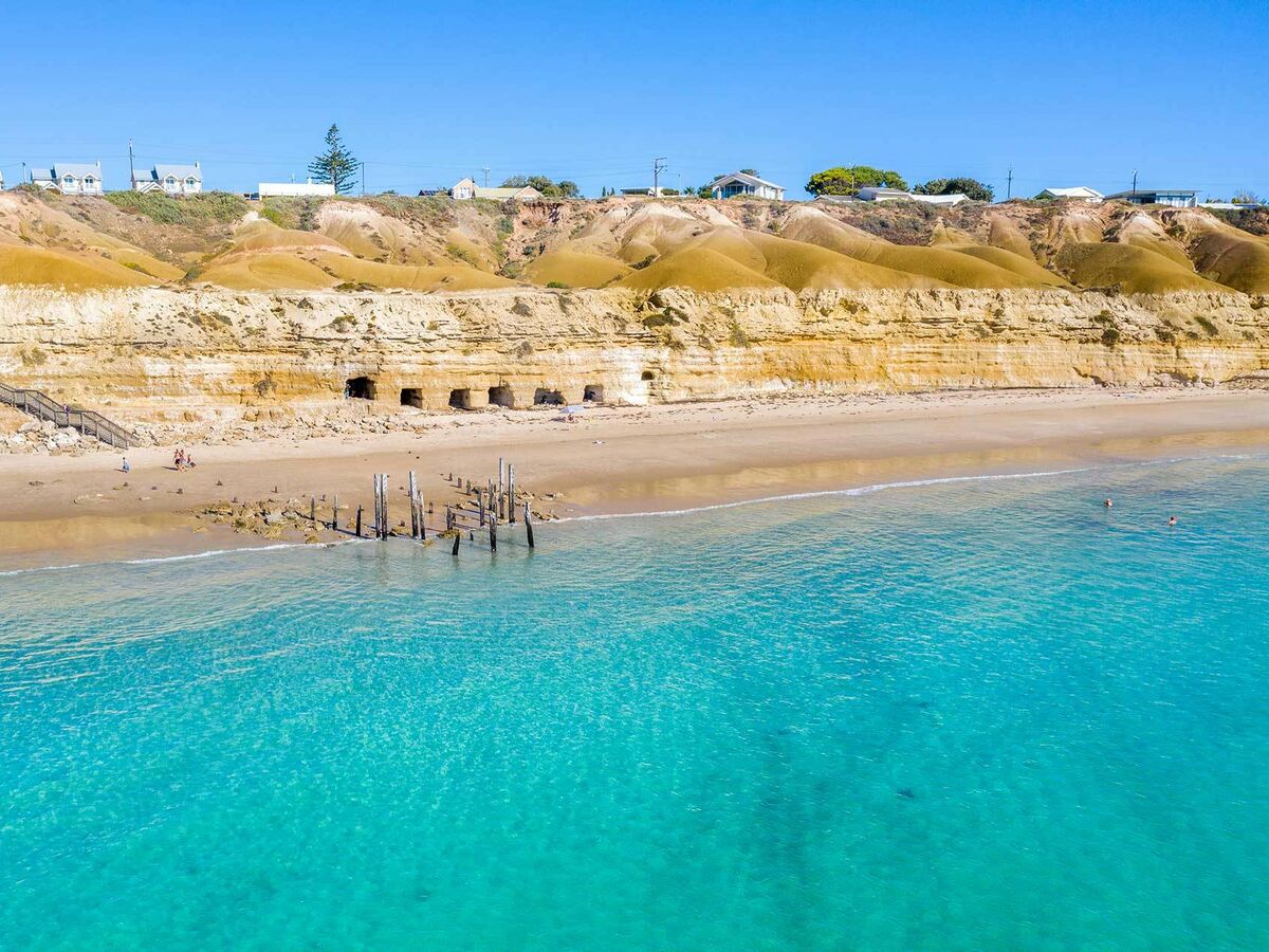 The sandhills and caves of Port Willunga Beach, viewed from the turquoise waters, South Australia
